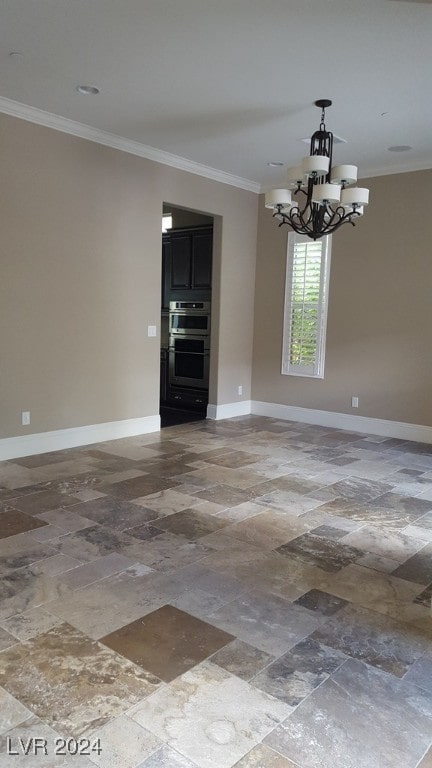 unfurnished dining area featuring ornamental molding and an inviting chandelier