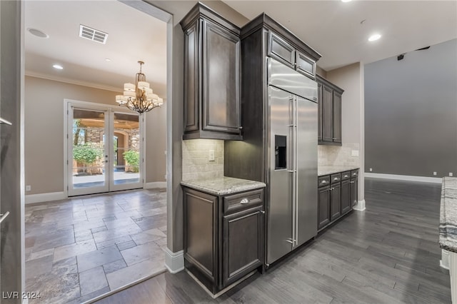 2804 Josephine Dr, Henderson, NV 89044 - kitchen with baseboards, light stone counters, backsplash, a chandelier, and crown molding