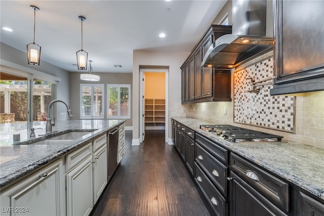 2804 Josephine Dr, Henderson, NV 89044 - kitchen featuring a sink, stainless steel appliances, wall chimney range hood, light stone counters, and baseboards