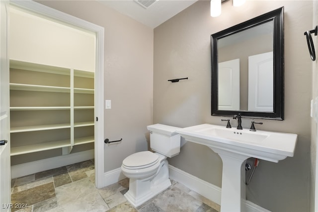2804 Josephine Dr, Henderson, NV 89044 - half bath with toilet, baseboards, and stone finish flooring