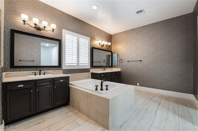 2804 Josephine Dr, Henderson, NV 89044 - full bathroom with two vanities, wood tiled floors, and a bath