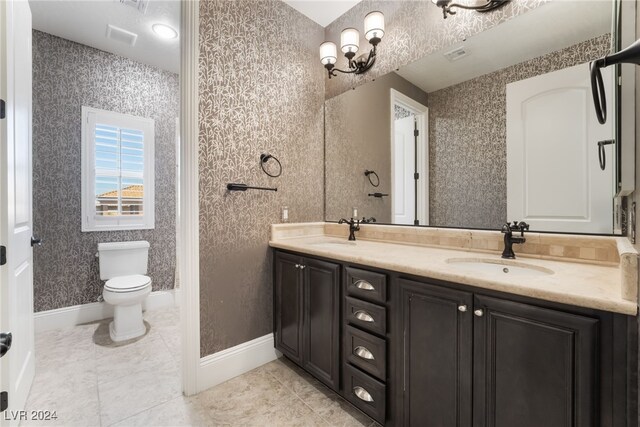2804 Josephine Dr, Henderson, NV 89044 - bathroom with toilet, double vanity, and baseboards