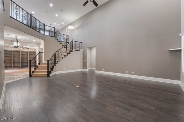 2804 Josephine Dr, Henderson, NV 89044 - unfurnished living room featuring stairway, ceiling fan, a high ceiling, baseboards, and wood finished floors