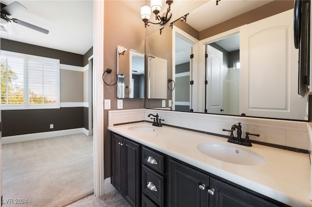 2804 Josephine Dr, Henderson, NV 89044 - bathroom featuring a ceiling fan, double vanity, baseboards, and a chandelier