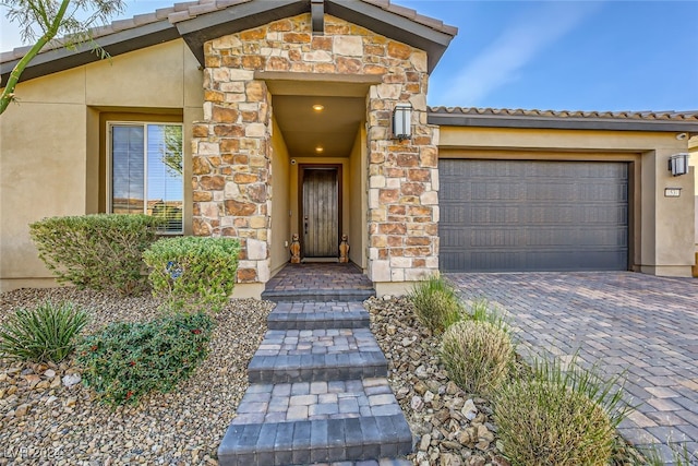 doorway to property with a garage