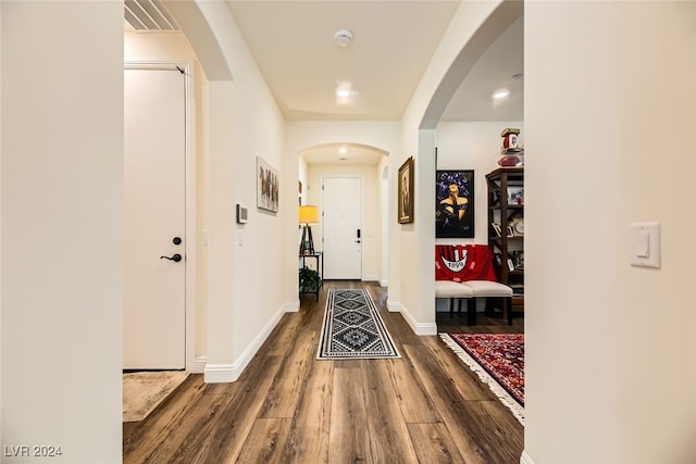 hall with hardwood / wood-style flooring