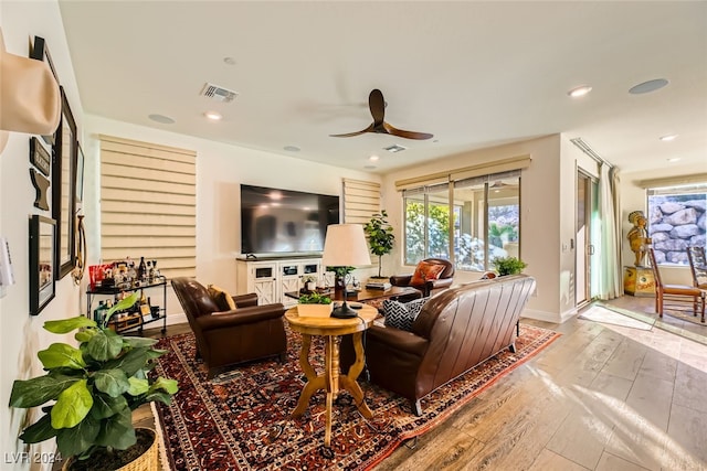 living room with ceiling fan and light wood-type flooring