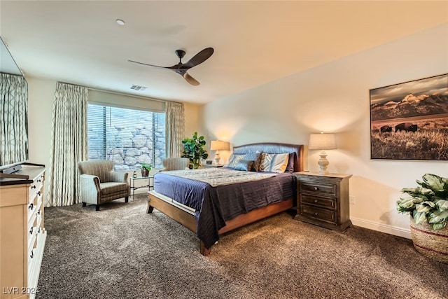 bedroom with dark colored carpet and ceiling fan