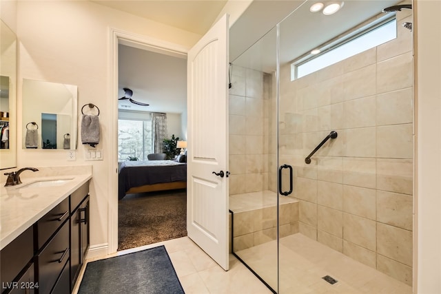 bathroom featuring tile patterned floors, vanity, a healthy amount of sunlight, and a shower with shower door