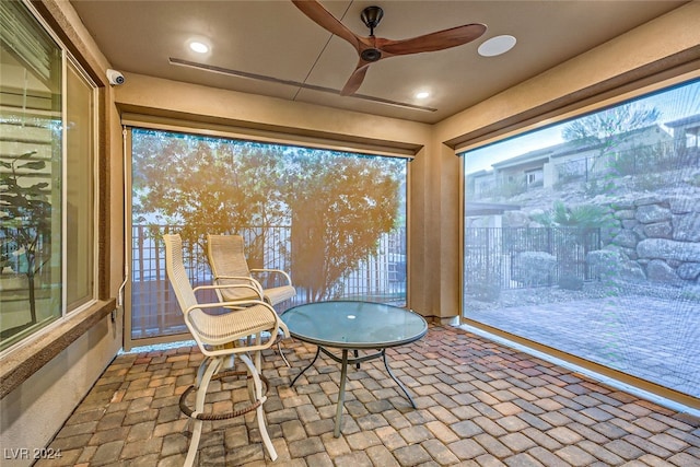 unfurnished sunroom featuring a wealth of natural light and ceiling fan