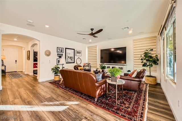 living room featuring ceiling fan and hardwood / wood-style floors