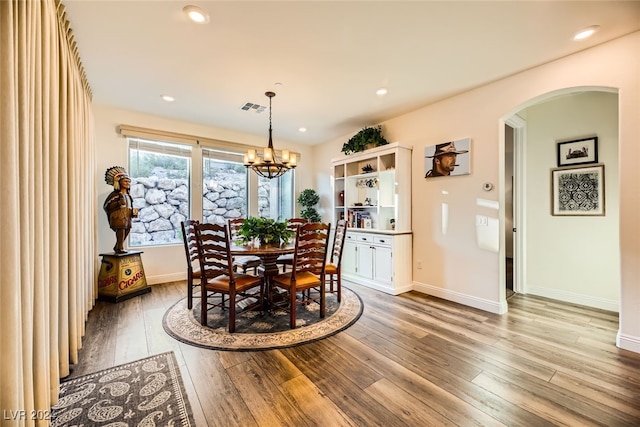 dining area featuring a chandelier and light hardwood / wood-style flooring