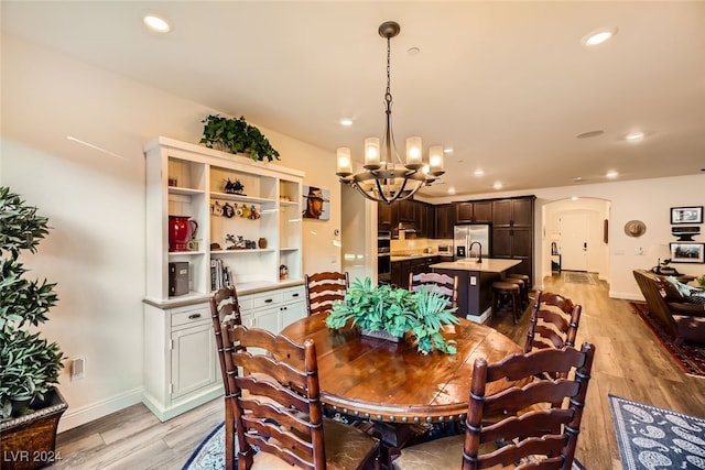 dining area featuring a chandelier and light hardwood / wood-style floors