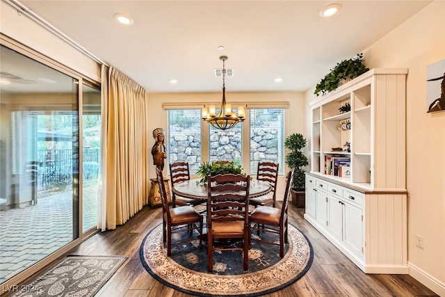 dining space with a chandelier and dark hardwood / wood-style floors