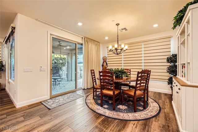 dining space featuring dark hardwood / wood-style floors and an inviting chandelier