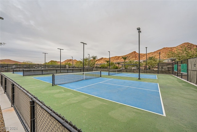 view of sport court featuring a mountain view and basketball court