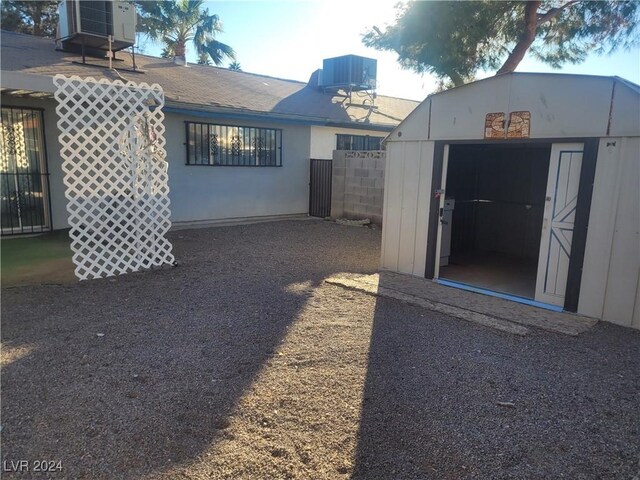 exterior space featuring cooling unit and a storage unit