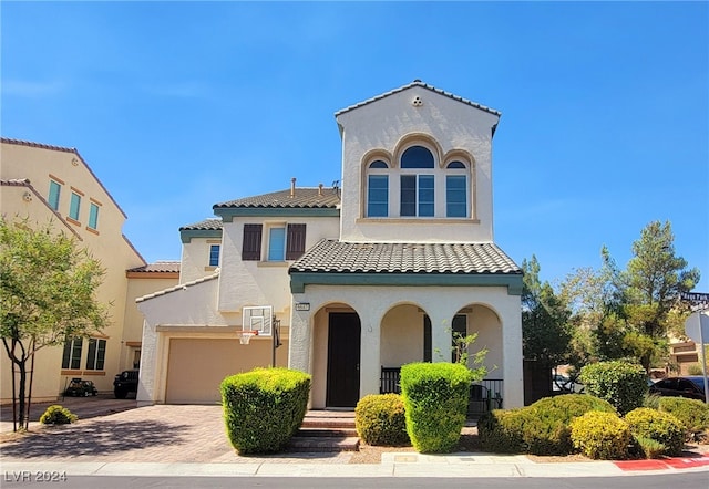 mediterranean / spanish-style home with a garage