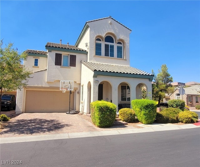 mediterranean / spanish house with a garage