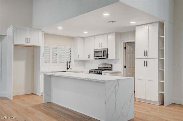 kitchen with a center island, white cabinetry, and stainless steel appliances