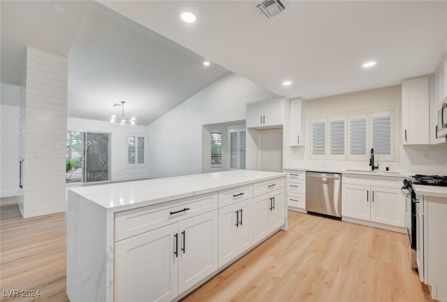 kitchen featuring white cabinets, dishwasher, white range with gas cooktop, and vaulted ceiling