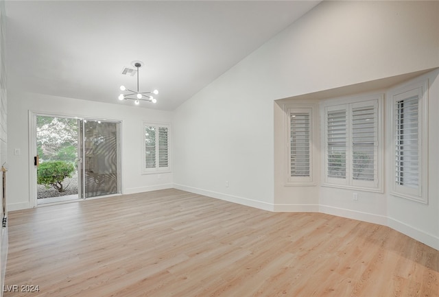 interior space with light hardwood / wood-style flooring, high vaulted ceiling, and a chandelier