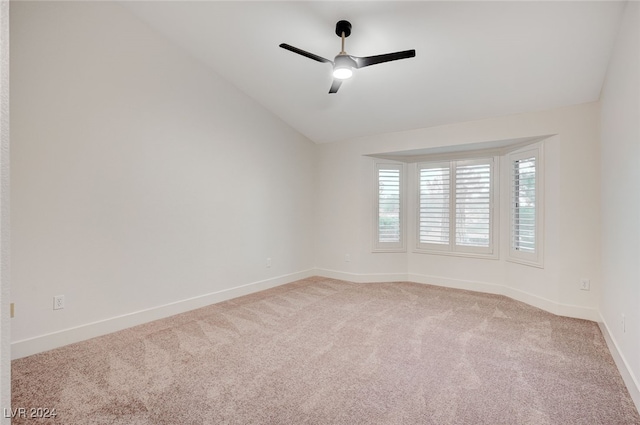 unfurnished room with carpet flooring, ceiling fan, and vaulted ceiling