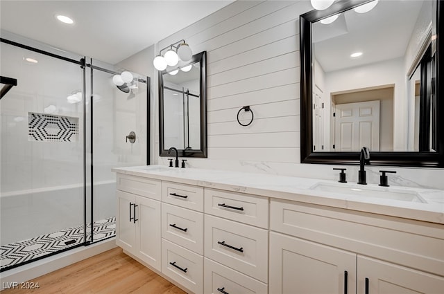 bathroom with vanity, wood-type flooring, and an enclosed shower