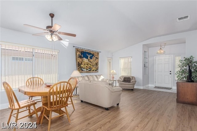 living room featuring ceiling fan, hardwood / wood-style floors, and lofted ceiling