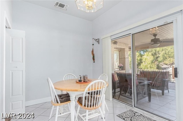 dining room with light tile patterned floors and ceiling fan with notable chandelier