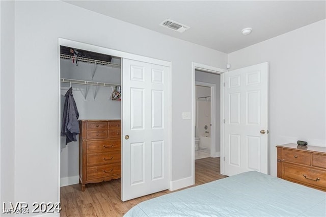 bedroom featuring light hardwood / wood-style floors and a closet