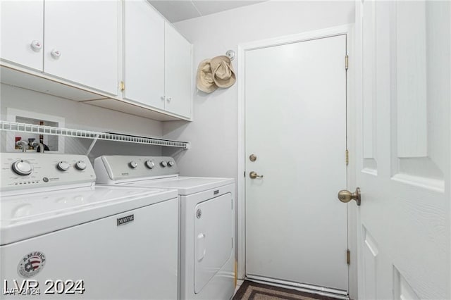 washroom featuring cabinets and washing machine and dryer