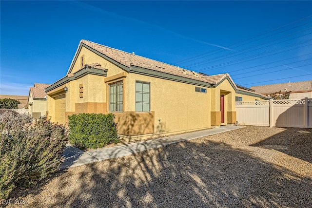 view of side of property with a garage