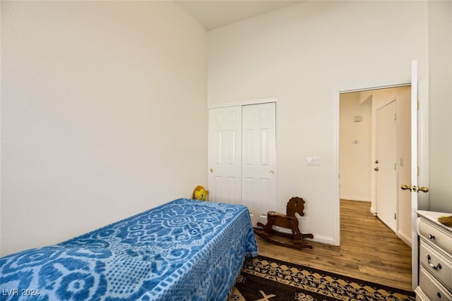 bedroom with a closet and dark wood-type flooring