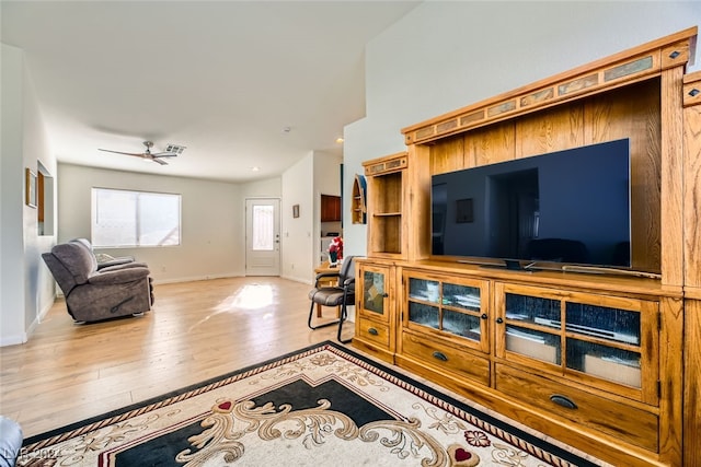 living room featuring light wood-type flooring and ceiling fan