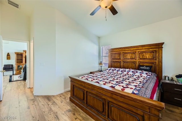 bedroom featuring light hardwood / wood-style flooring, ceiling fan, and lofted ceiling