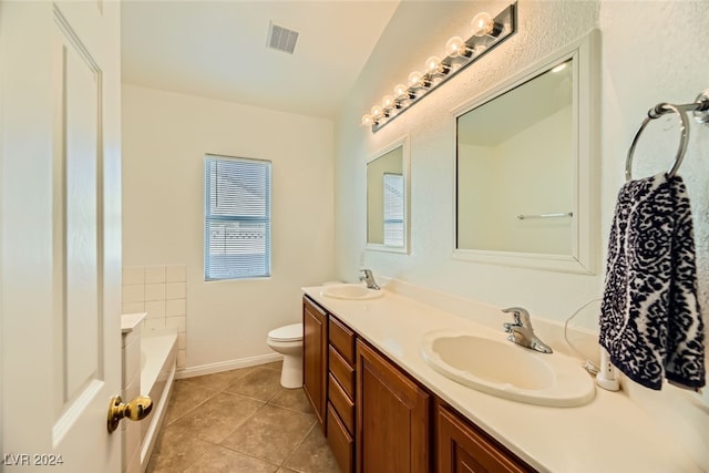 bathroom with tile patterned flooring, vanity, a bath, and toilet