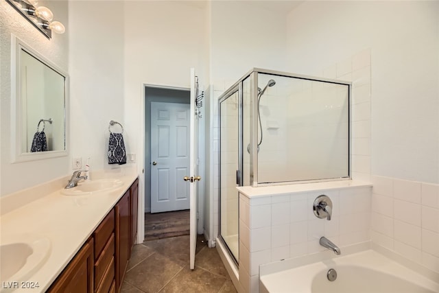 bathroom featuring tile patterned flooring, vanity, and shower with separate bathtub