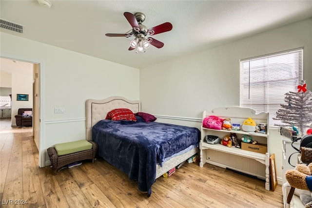 bedroom with light wood-type flooring and ceiling fan