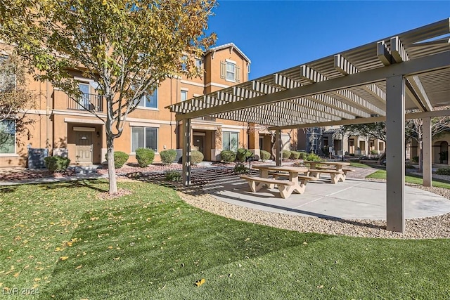 view of home's community with a pergola and a lawn