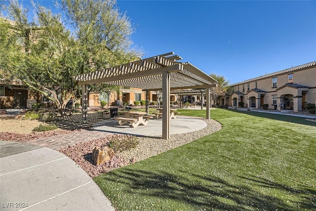 view of home's community with a pergola and a lawn