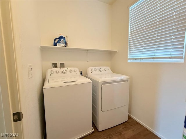 washroom with washer and dryer and wood-type flooring