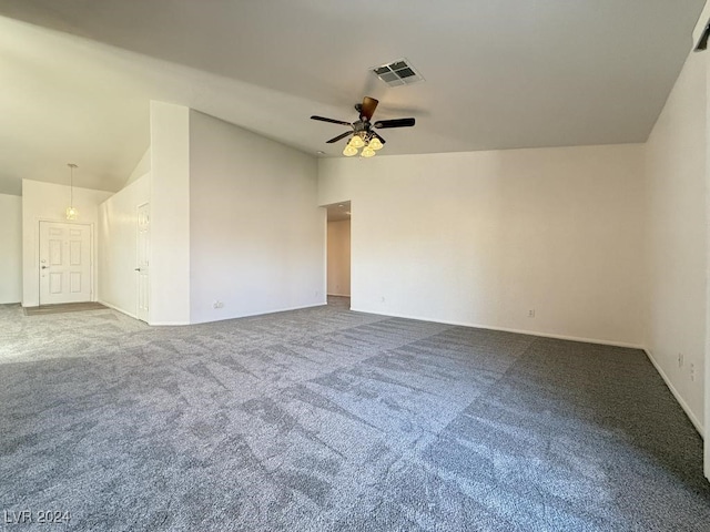 carpeted empty room with vaulted ceiling and ceiling fan