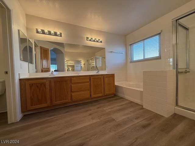 full bathroom with separate shower and tub, vanity, wood-type flooring, and toilet