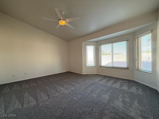 carpeted spare room featuring ceiling fan and lofted ceiling