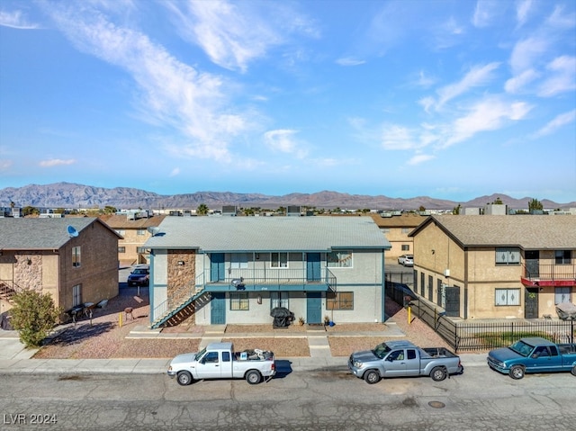 view of front of house featuring a mountain view and a balcony