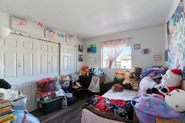 4740 Corsaire Ave, Las Vegas, NV 89115 - bedroom with dark wood-style flooring and a closet