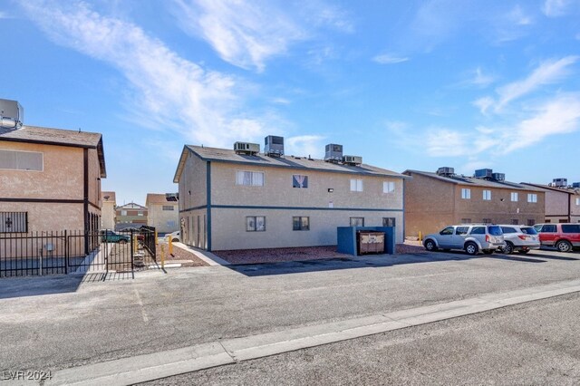 4740 Corsaire Ave, Las Vegas, NV 89115 - view of building exterior featuring a residential view, uncovered parking, and central air condition unit