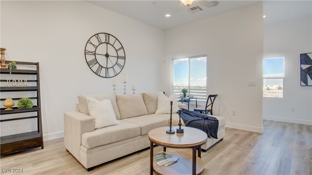 living room featuring ceiling fan, a healthy amount of sunlight, and light hardwood / wood-style floors