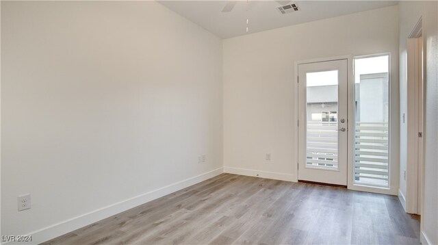 empty room featuring ceiling fan and light hardwood / wood-style flooring